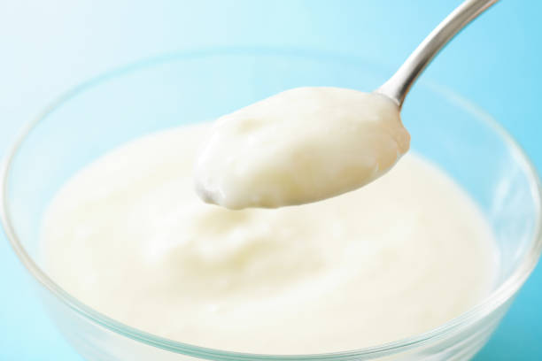 istock White Yogurt In Bowl. blue background. 1150185801