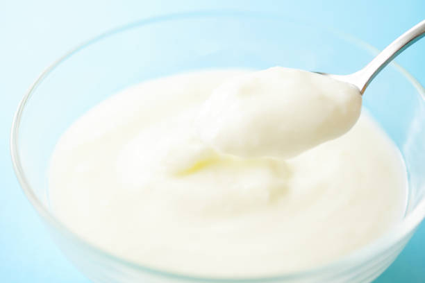 istock White Yogurt In Bowl. blue background. 1150185814