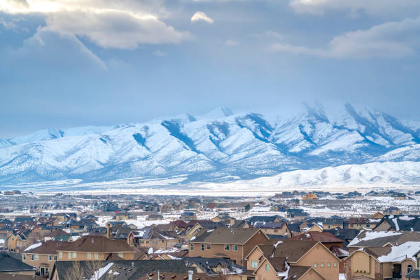 istock Homes with a snowy mountain and cloudy sky background viewed in winter 1150186111