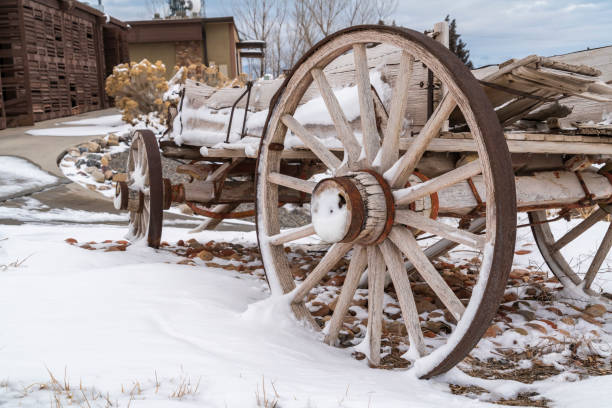istock Old and rusty wooden wagon on a snow covered landscape viewed in winter 1150186128