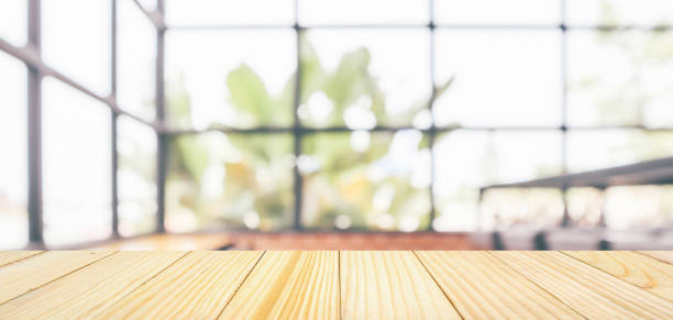 istock Empty wooden table top with cafe restaurant coffee shop window interior abstract blur defocused with bokeh light background for montage product display 1150189421