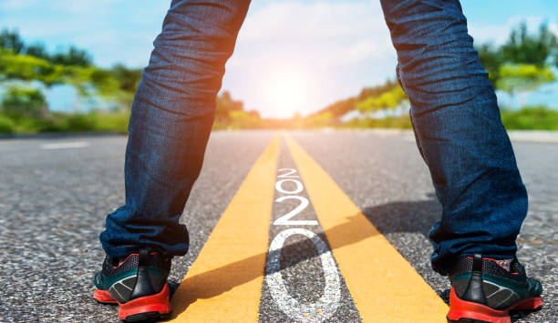istock Man standing on the road with writing Number 2020 1150191233
