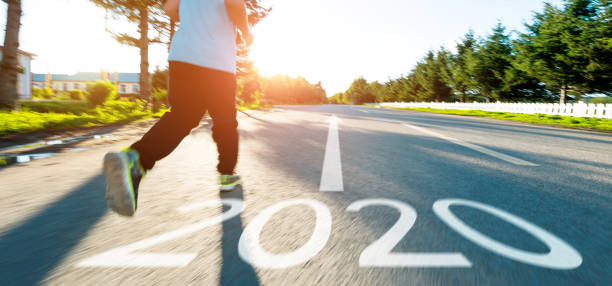 istock Boy running on the road with writing Number 2020 1150191264
