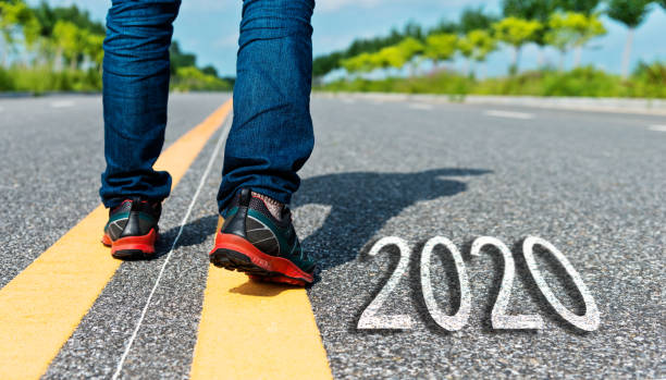 istock Man walking on the road with writing Number 2020 1150191387