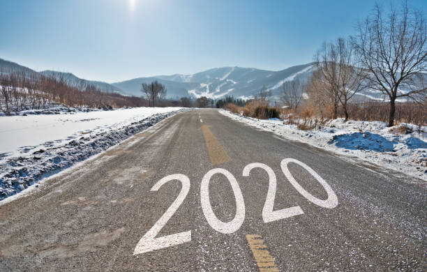 istock Number 2020 on winter asphalt road 1150192880