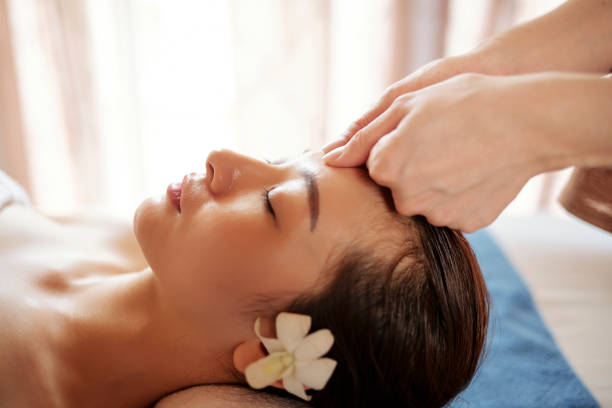istock Beautician massaging forehead of client 1150195860