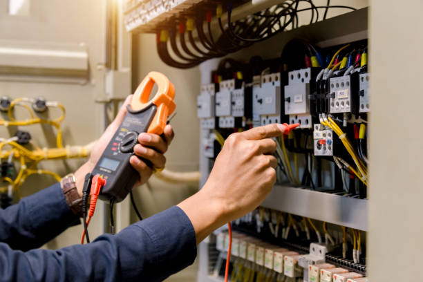 istock Electrician engineer work  tester measuring  voltage and current of power electric line in electical cabinet control. 1150199552