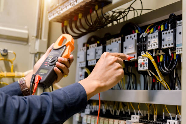 istock Electrician engineer work  tester measuring  voltage and current of power electric line in electical cabinet control. 1150199580