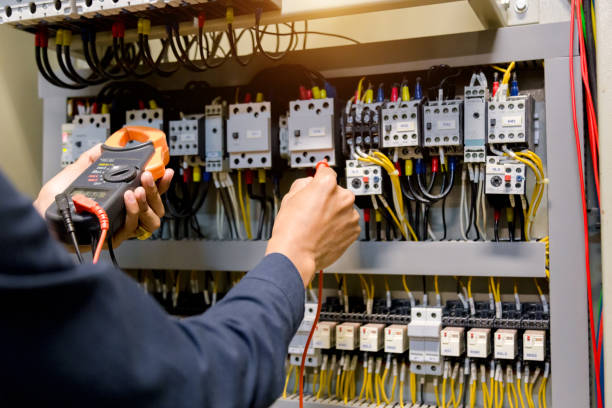istock Electrician engineer work  tester measuring  voltage and current of power electric line in electical cabinet control. 1150199608