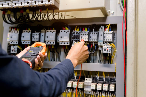 istock Electrician engineer work  tester measuring  voltage and current of power electric line in electical cabinet control. 1150199636