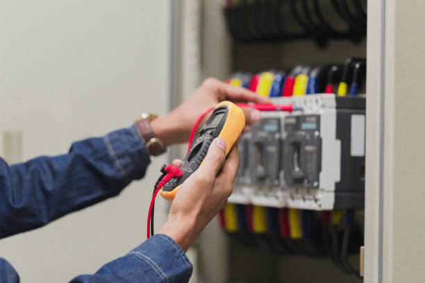 istock Electrician engineer work  tester measuring  voltage and current of power electric line in electical cabinet control. 1150199672