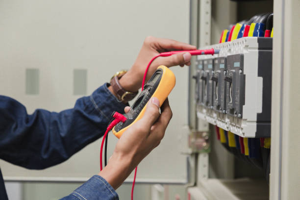 istock Electrician engineer work  tester measuring  voltage and current of power electric line in electical cabinet control. 1150199698