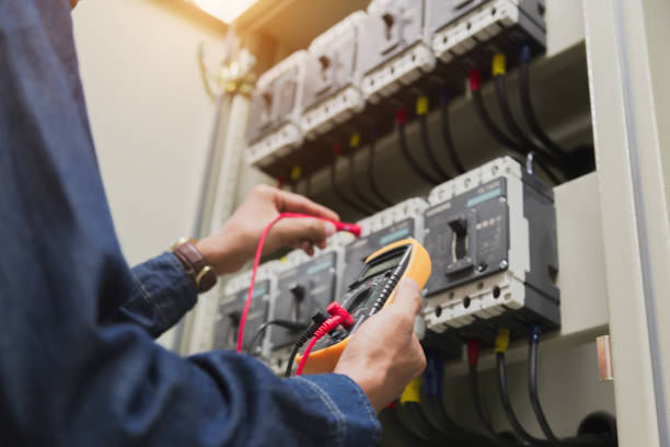 istock Electrician engineer work  tester measuring  voltage and current of power electric line in electical cabinet control. 1150199734