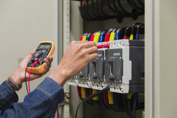 istock Electrician engineer work  tester measuring  voltage and current of power electric line in electical cabinet control. 1150199768