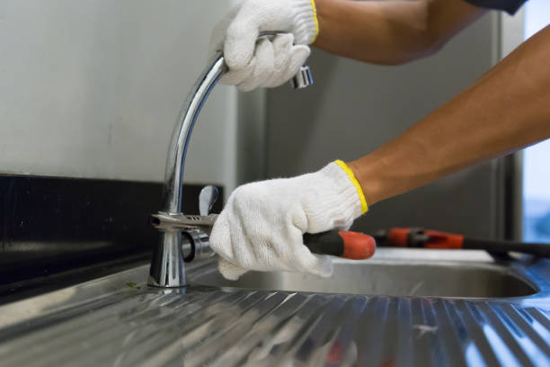 istock Plumber fixing white sink pipe with adjustable wrench. 1150199888