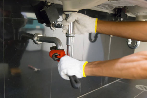 istock Plumber fixing white sink pipe with adjustable wrench. 1150200570