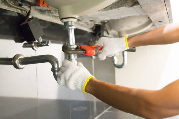 istock Plumber fixing white sink pipe with adjustable wrench. 1150200572