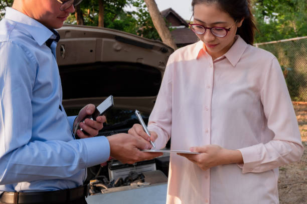 istock Insurance agent writing document on clipboard examining car after accident, Insurance concept 1150200832