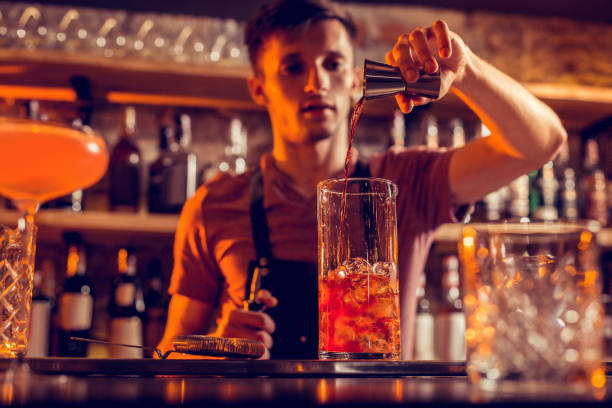 istock Man working in the bar pouring alcohol into glass 1150202389