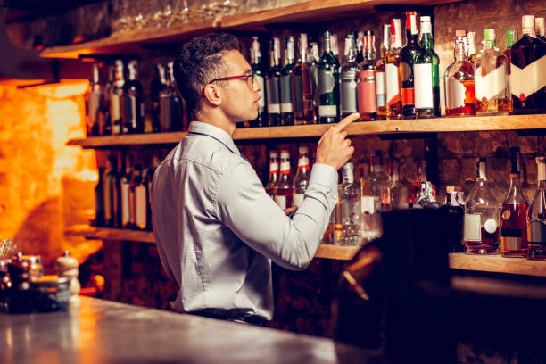 istock Man standing near bar stand and ordering alcohol for restaurant 1150202516