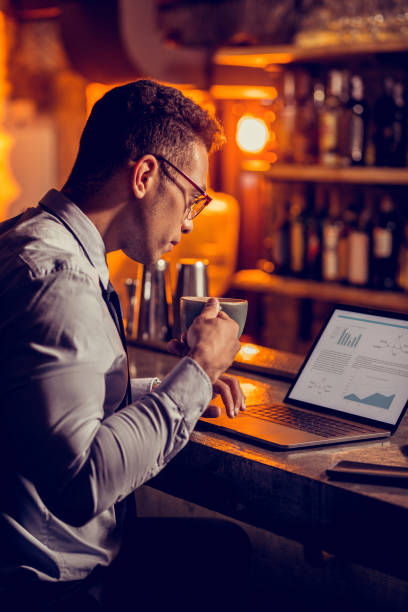 istock Freelancer drinking coffee and working sitting in his restaurant 1150202542