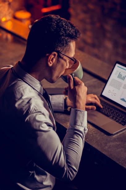 istock Businessman drinking cappuccino and working on laptop 1150202550