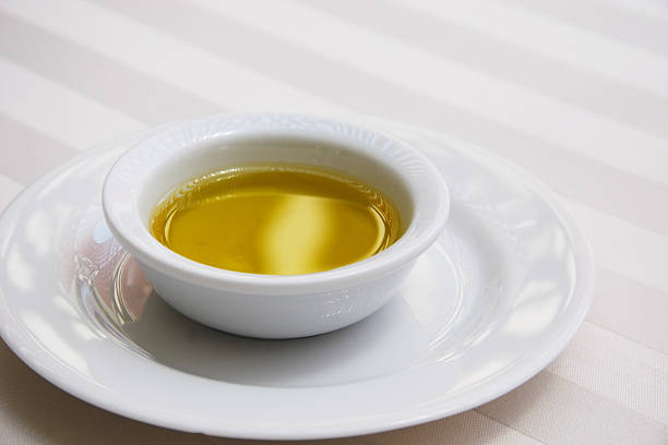 istock Golden Olive Oil on White Tablecloth 115020617