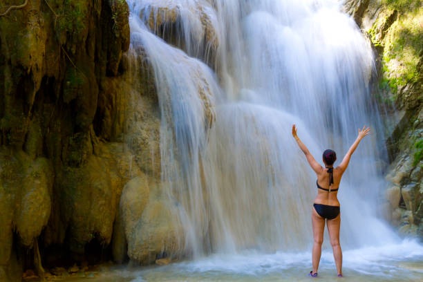 istock Woman with bikini happy at Erawan Waterfall and  natural 1150214878