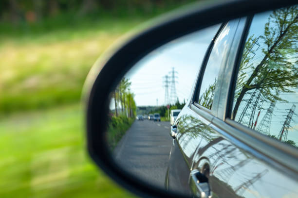 istock car on the road, rear view from side mirror. 1150215096