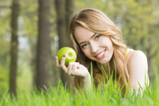 Portrait of a smiling girl with an apple