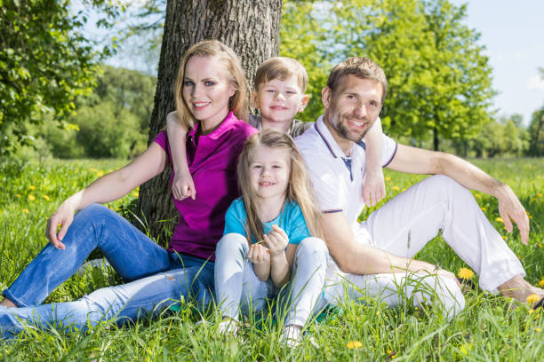 istock Family sitting under the tree 1150215193