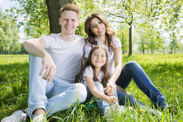istock Family sitting under the tree 1150215207