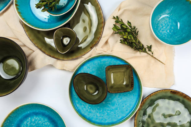 istock Simple rustic handmade blue crockery against white wooden wall: dish, stack of bowls. 1150223269