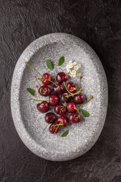 istock Cherry in the stone plate on pink table. 1150225053