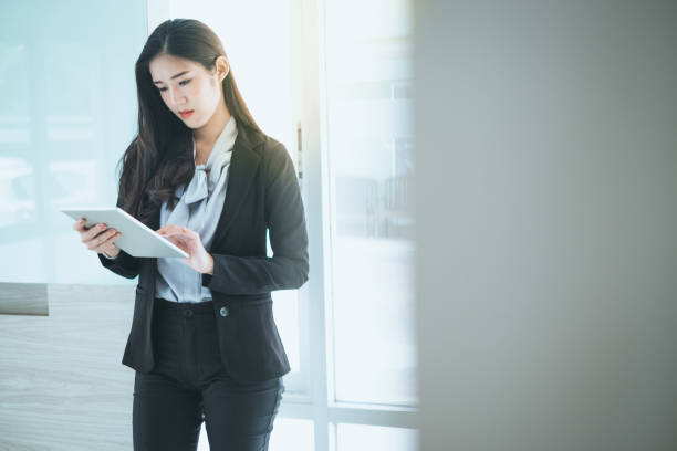 istock Beautiful businesswoman looking at tablet while she working in her workplace. 1150227206