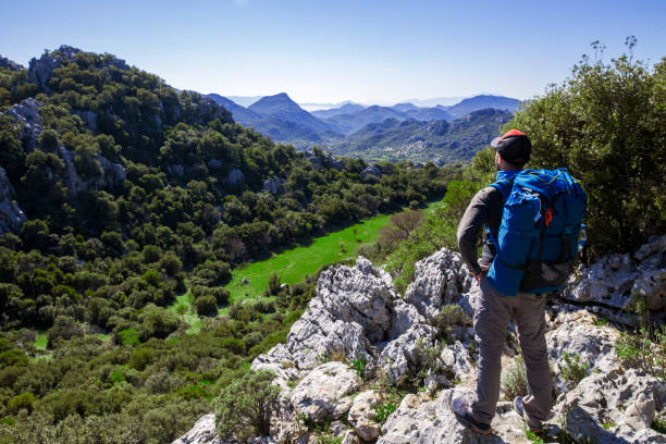 istock Man on the historical roadside with beauty mountains. 1150227522
