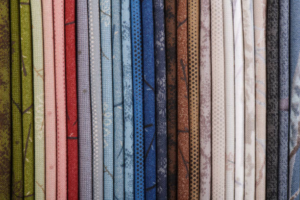istock Stack of colorful cotton quilting fabrics as a background image 1150228877