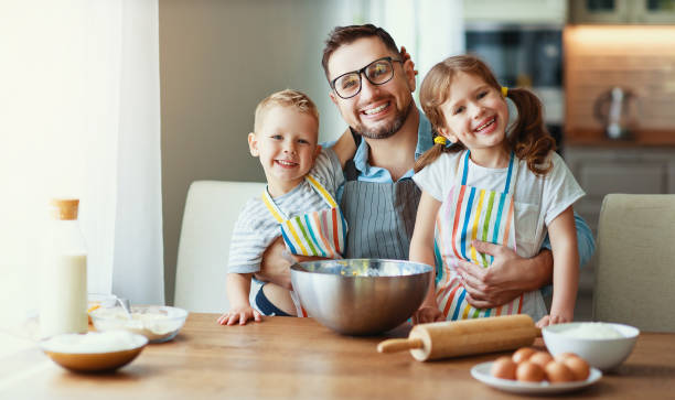 istock father with children   baking cookies 1150233138