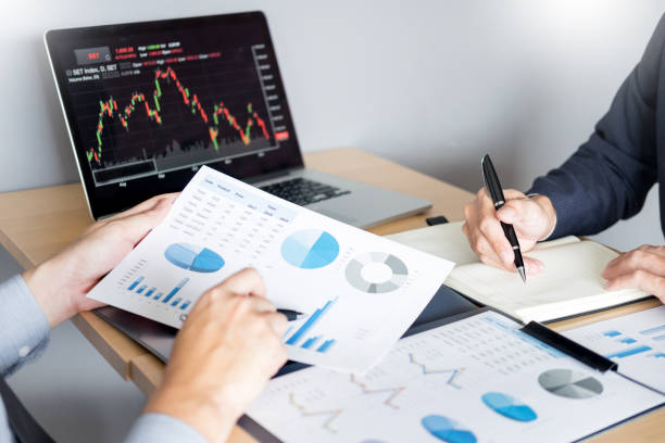 istock Cropped Hands Of Business People Analyzing Graphs On Table 1150233370