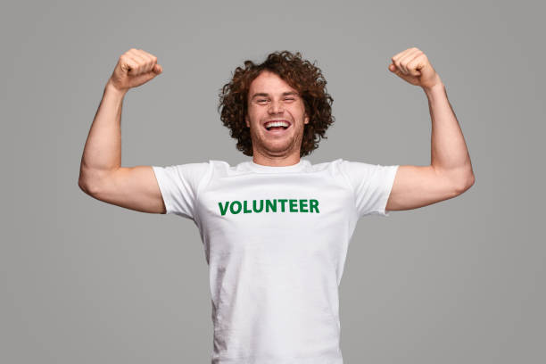istock Strong volunteer smiling and flexing muscles 1150239910