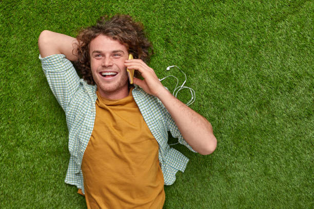 istock Man speaking on phone on lawn 1150239918