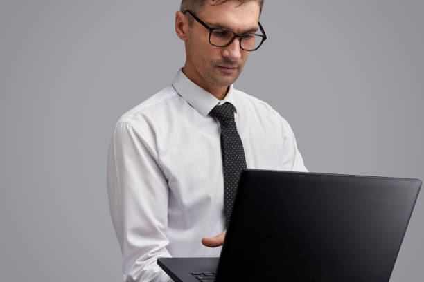 istock Serious businessman browsing laptop 1150240134