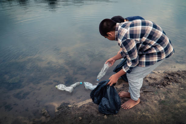 istock Volunteers Removing Plastic Bottles From Lake 1150240588