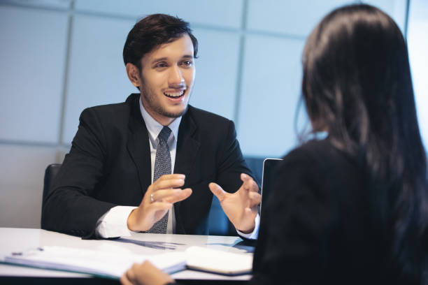 istock Businessman Talking While Sitting At Desk In Office 1150241093