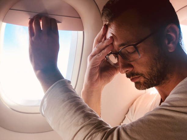 istock Tired / sick passenger in a modern airplane seat next to the window. 1150245478