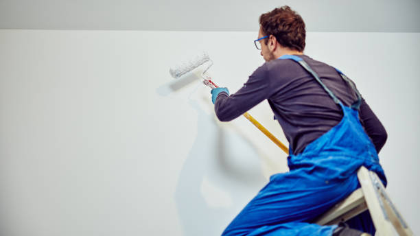 istock Worker painting walls inside the house - renovation fixes. 1150245777