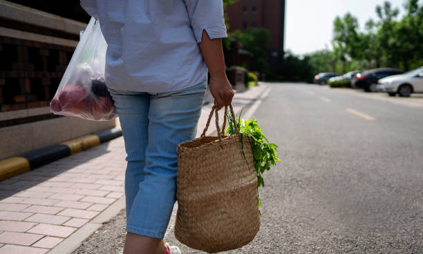 istock young woman carrying vegetable basket walking 1150249083
