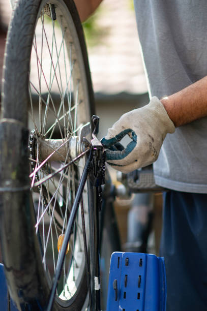 istock Hobby mechanic in overall repairs a bicycle 1150251326