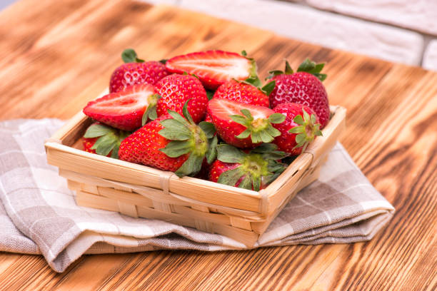 istock Fresh strawberries in a wooden bowl on the table 1150251363