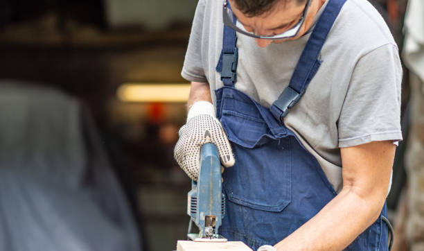 istock Mature carpenter cutting wooden plank 1150251430